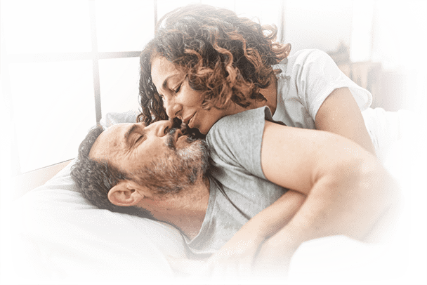 happy couple in bed representing improved confidence and lifestyle from prostate health support